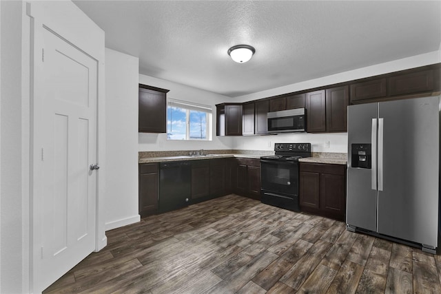 kitchen featuring dark brown cabinets, sink, dark hardwood / wood-style floors, and black appliances