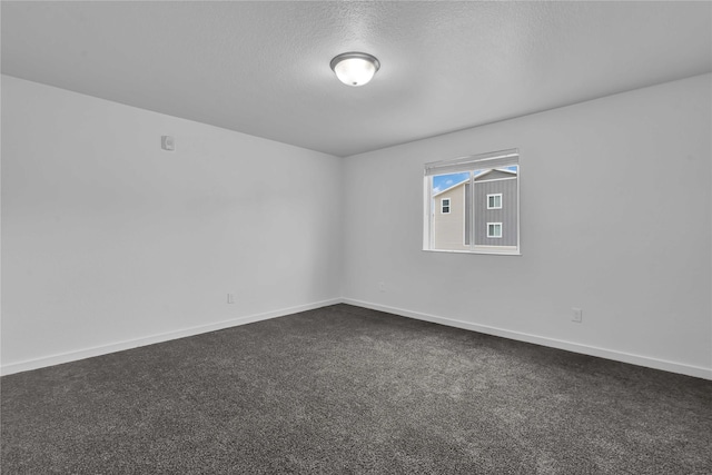 carpeted spare room featuring a textured ceiling