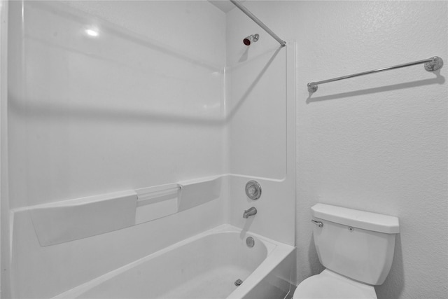 bathroom featuring shower / tub combination and toilet