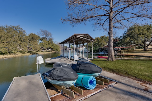 view of dock with a yard and a water view