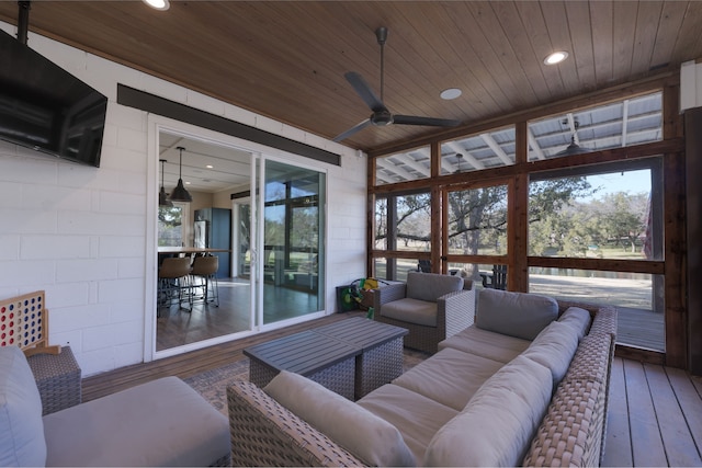 sunroom featuring wood ceiling and ceiling fan