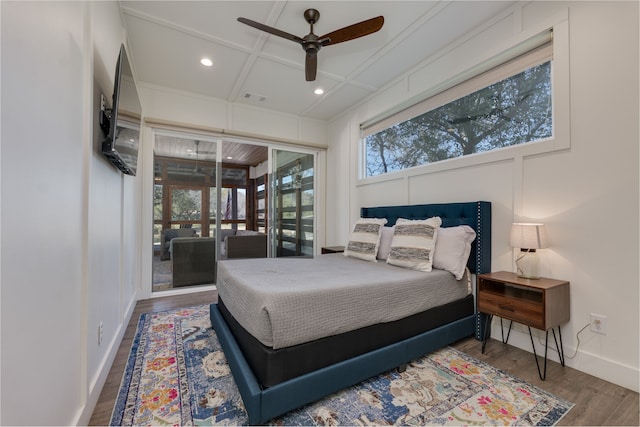 bedroom featuring hardwood / wood-style flooring, ceiling fan, coffered ceiling, and access to outside