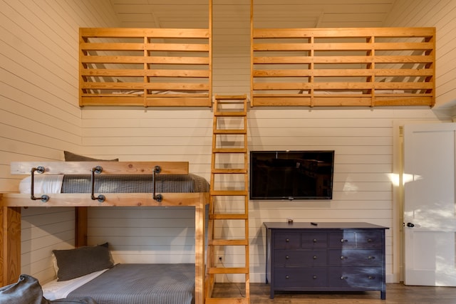 unfurnished bedroom featuring wooden walls