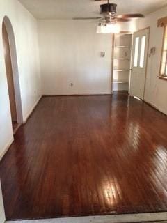 spare room featuring ceiling fan and dark hardwood / wood-style flooring