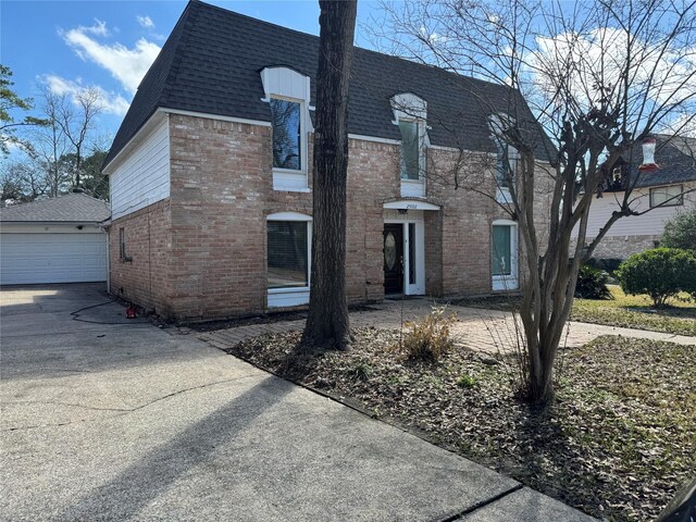 view of front of home with a garage and an outdoor structure