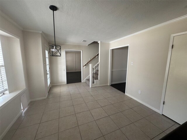 unfurnished dining area featuring crown molding, a healthy amount of sunlight, and light tile patterned floors