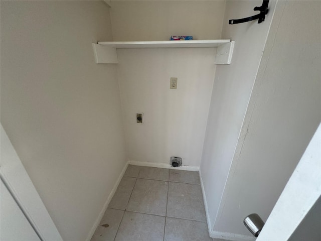 clothes washing area with electric dryer hookup and light tile patterned floors