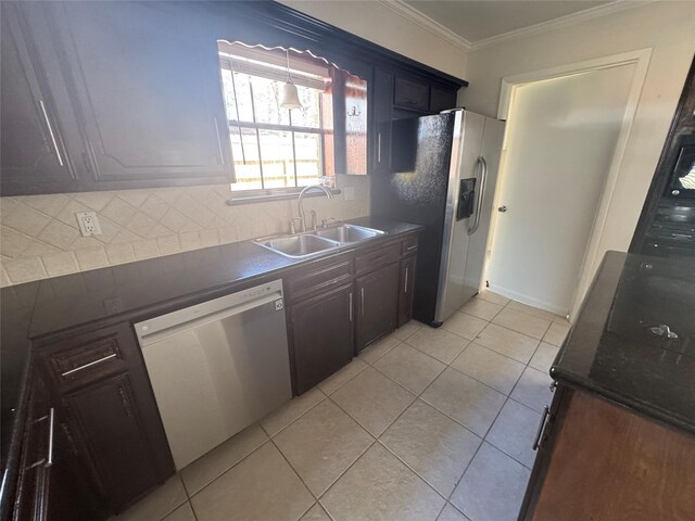 kitchen featuring sink, light tile patterned floors, appliances with stainless steel finishes, ornamental molding, and decorative backsplash