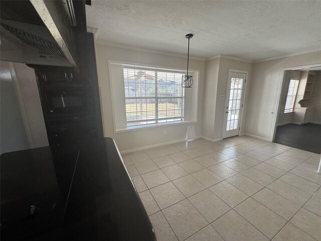 unfurnished dining area with light tile patterned floors, crown molding, and a textured ceiling