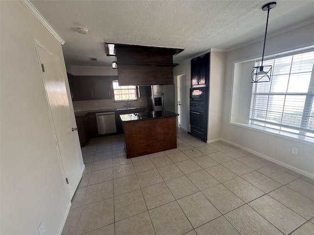 kitchen with sink, ornamental molding, stainless steel appliances, and a center island