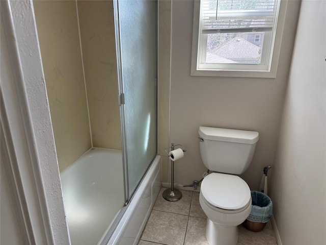 bathroom with tile patterned flooring, enclosed tub / shower combo, and toilet