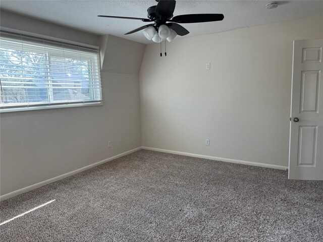 empty room featuring ceiling fan, carpet floors, and a textured ceiling