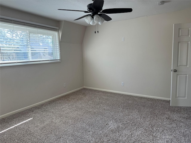 spare room with ceiling fan, carpet, and a textured ceiling