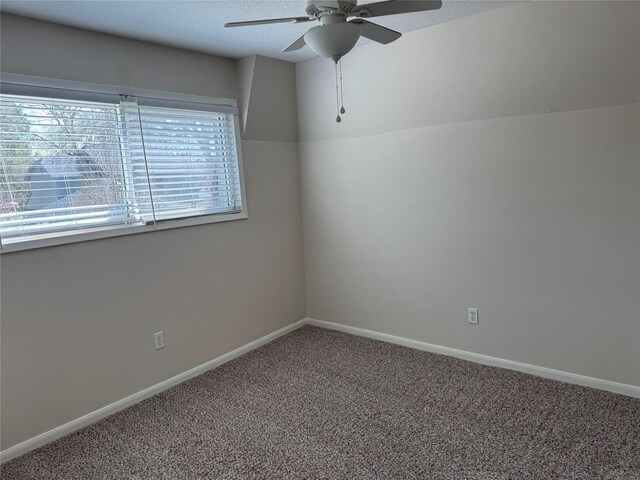 carpeted empty room featuring a textured ceiling and ceiling fan