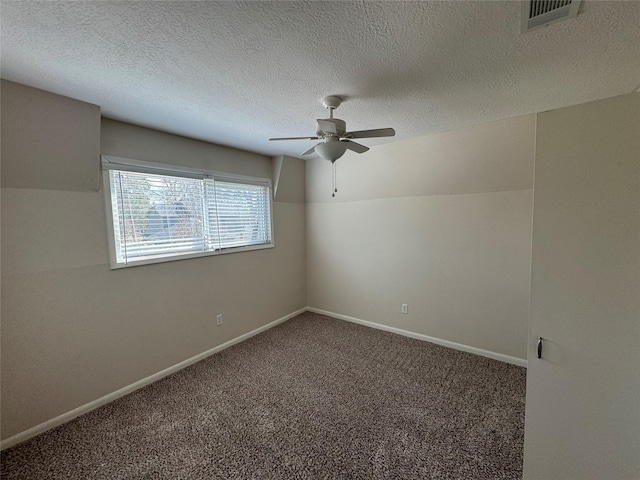 carpeted empty room featuring a textured ceiling and ceiling fan