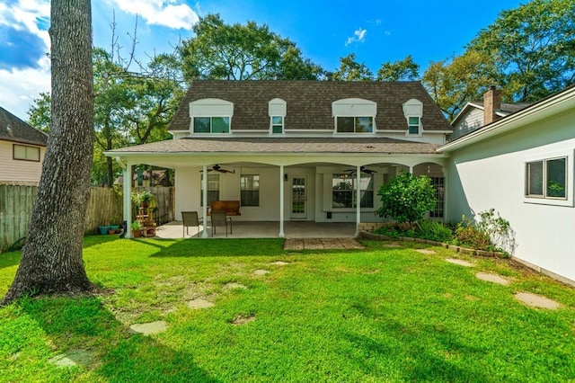 rear view of property featuring a yard, a patio, and ceiling fan