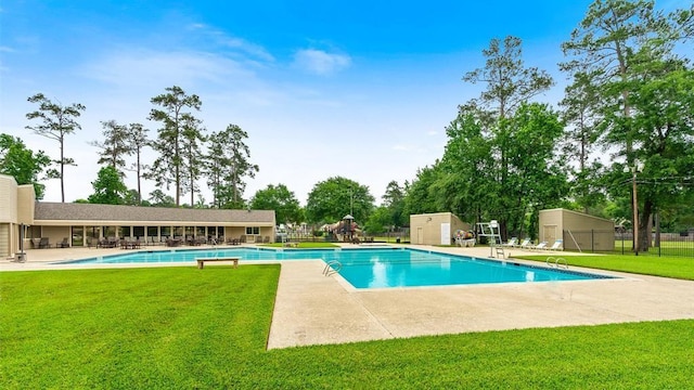 view of pool featuring a patio and a yard