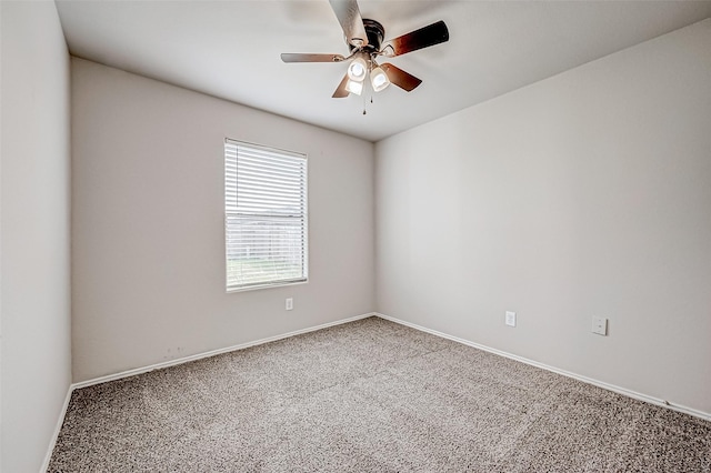 spare room with carpet, baseboards, and a ceiling fan