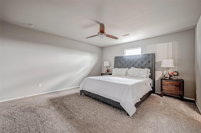 carpeted bedroom featuring baseboards, visible vents, and a ceiling fan