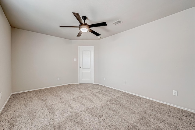 unfurnished room with baseboards, carpet floors, visible vents, and a ceiling fan