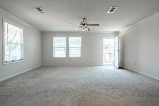 spare room with crown molding, light colored carpet, and ceiling fan