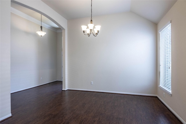 empty room with lofted ceiling, dark hardwood / wood-style flooring, a chandelier, and a wealth of natural light