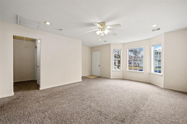 carpeted empty room featuring ceiling fan