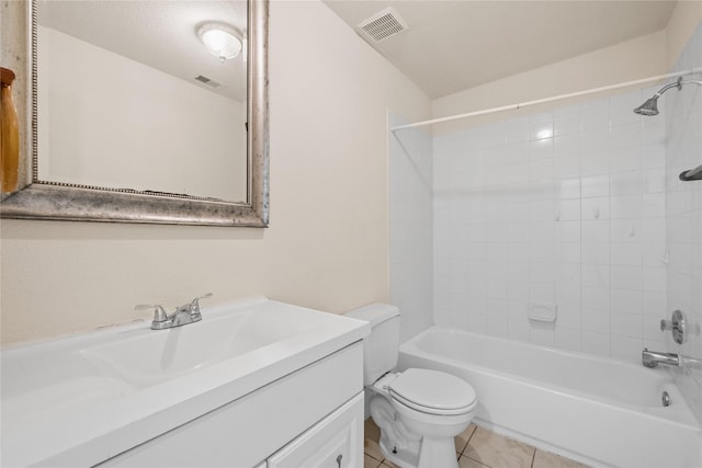 full bathroom with tiled shower / bath combo, vanity, tile patterned floors, and toilet