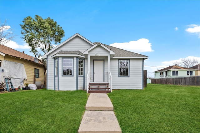 bungalow-style house with a front lawn