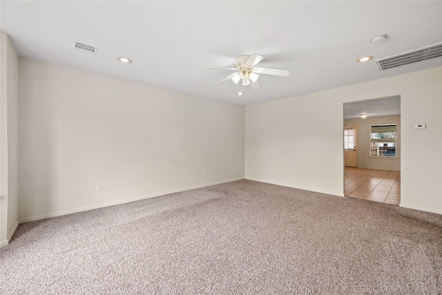 empty room with ceiling fan and light colored carpet