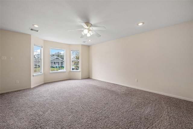 carpeted spare room with ceiling fan