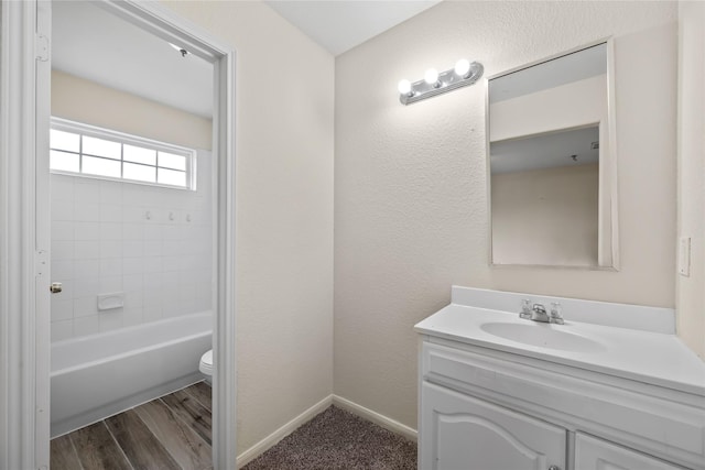 full bathroom featuring hardwood / wood-style flooring, vanity, toilet, and tiled shower / bath combo