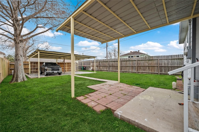 view of yard featuring a carport and a patio