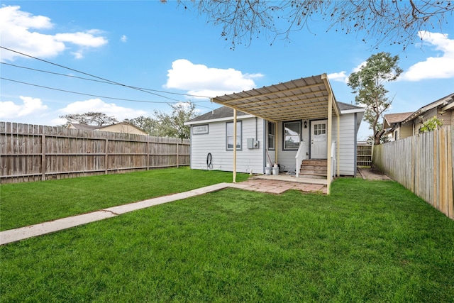 rear view of property with a lawn