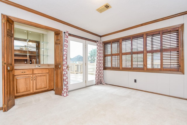 carpeted empty room with ornamental molding