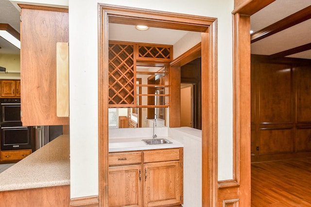 wine cellar with wood-type flooring and indoor wet bar