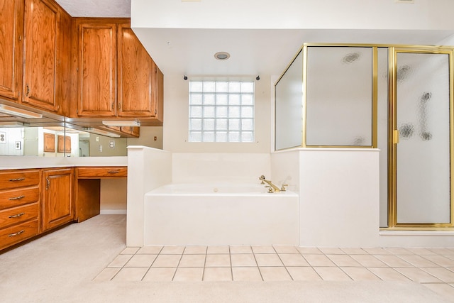 bathroom featuring vanity, plus walk in shower, and tile patterned flooring