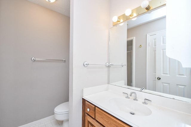 bathroom with vanity, tile patterned floors, a textured ceiling, and toilet