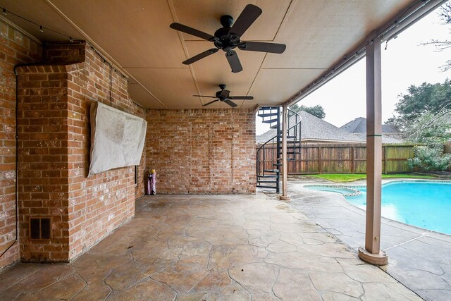 view of patio with a fenced in pool and ceiling fan