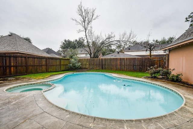 view of pool with a patio area and an in ground hot tub