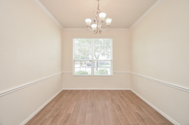 spare room with ornamental molding, a chandelier, and light wood-type flooring