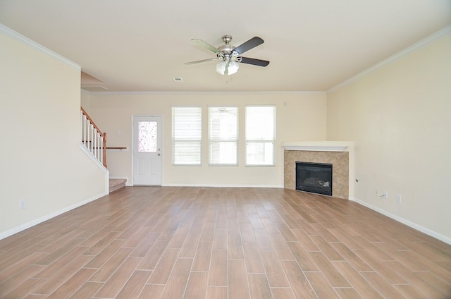 unfurnished living room with ornamental molding, ceiling fan, and light wood-type flooring