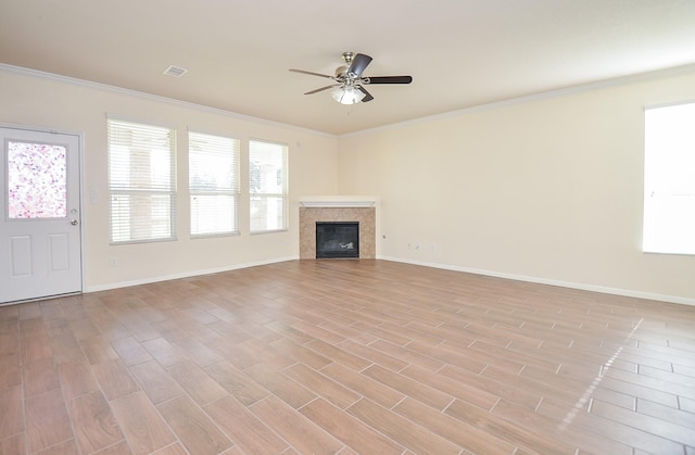 unfurnished living room featuring ornamental molding, ceiling fan, and light hardwood / wood-style floors