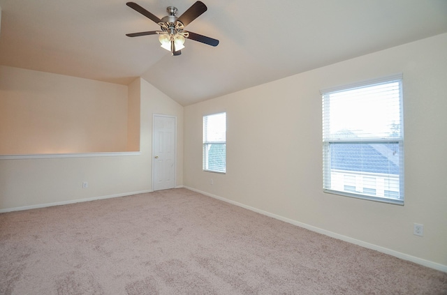 carpeted spare room with lofted ceiling and ceiling fan