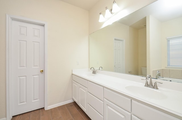 bathroom with vanity, hardwood / wood-style floors, and toilet