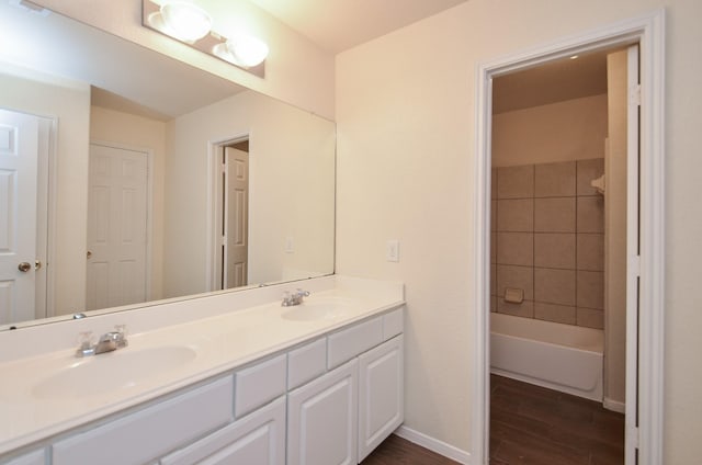 bathroom with vanity, hardwood / wood-style floors, and tiled shower / bath