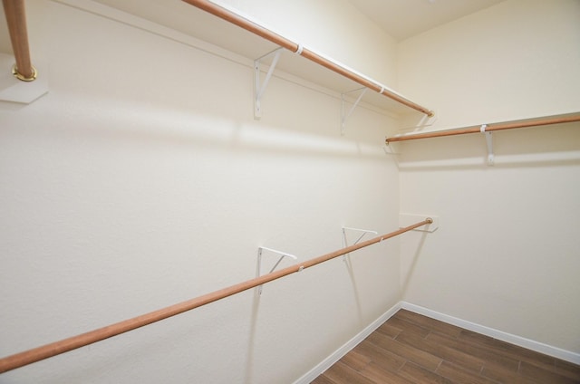 walk in closet featuring dark wood-type flooring