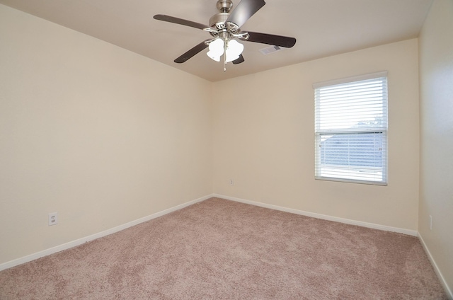 spare room featuring light colored carpet and ceiling fan