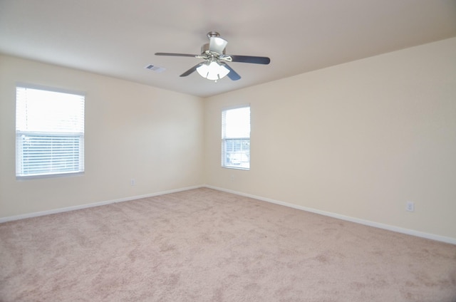 carpeted spare room with ceiling fan