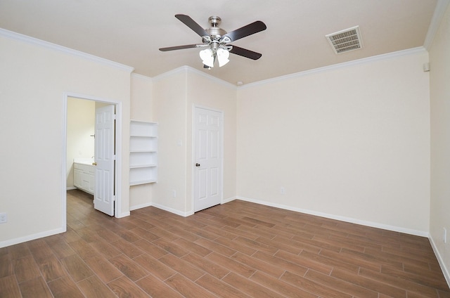 unfurnished bedroom with crown molding, connected bathroom, hardwood / wood-style flooring, and ceiling fan